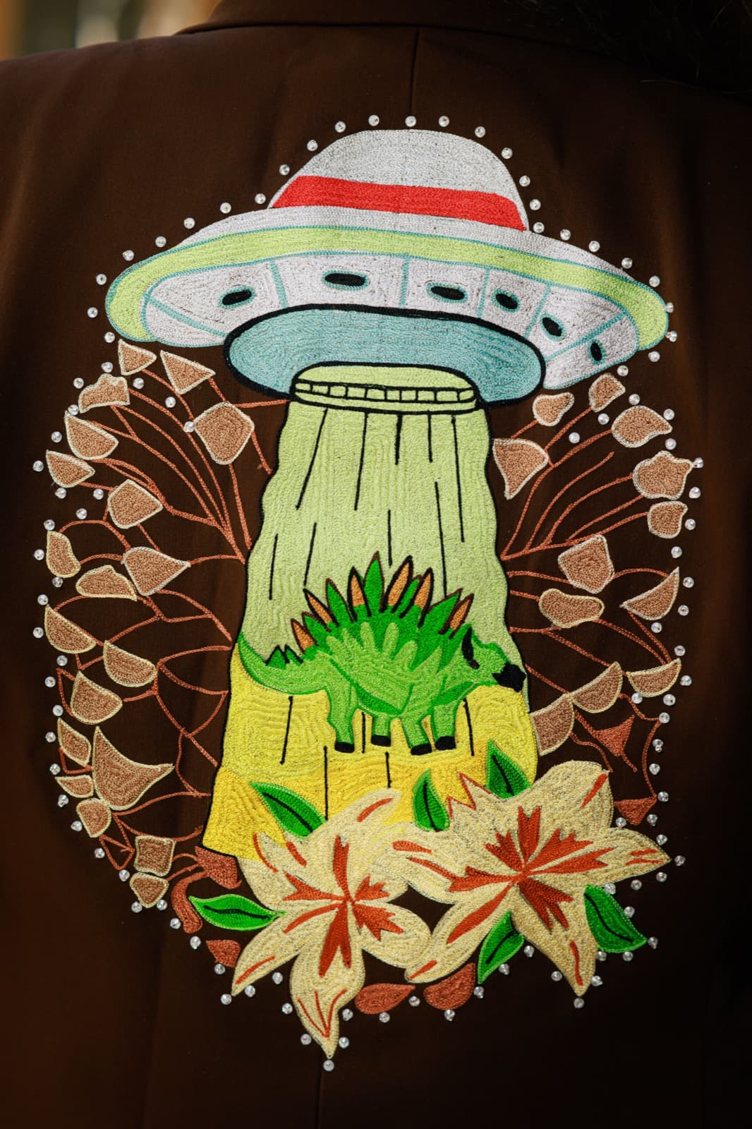 Hand-beaded flying-saucer embroidery on Zach's jacket